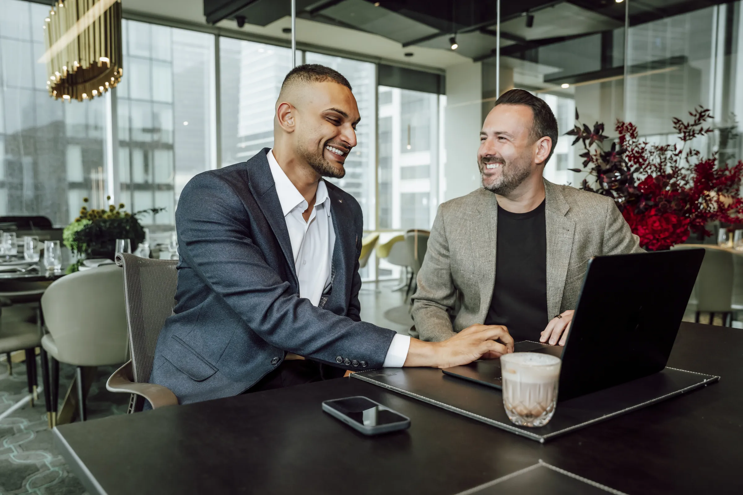 Tav Palapathwala working through a plan with a client in the office.